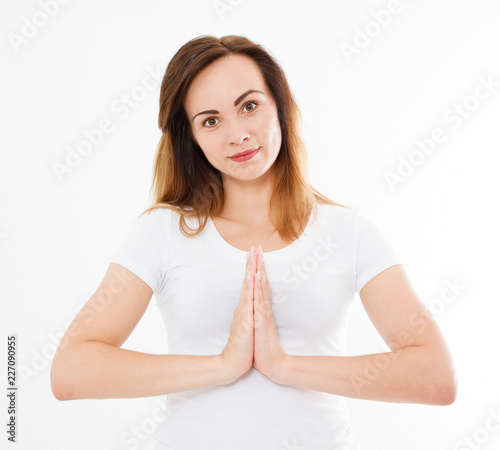 Close-up of hands of sexy woman in tshirt , meditating indoors, focus on arms in Namaste gesture. Asian medicine, yoga concept. Mock up. Copy space. Template. Blank.