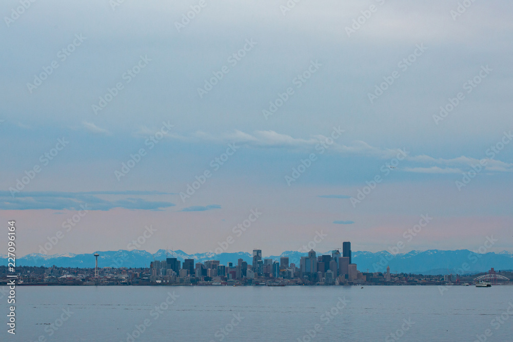 Seattle cityscape over water at sunset