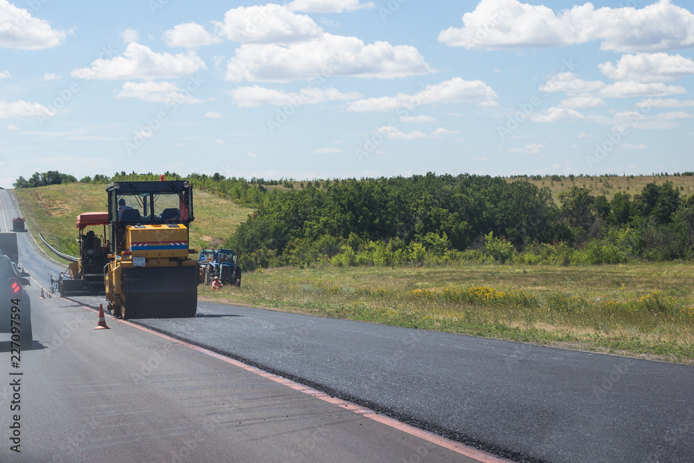 paver machine working on road repair paver machine working on road repair
