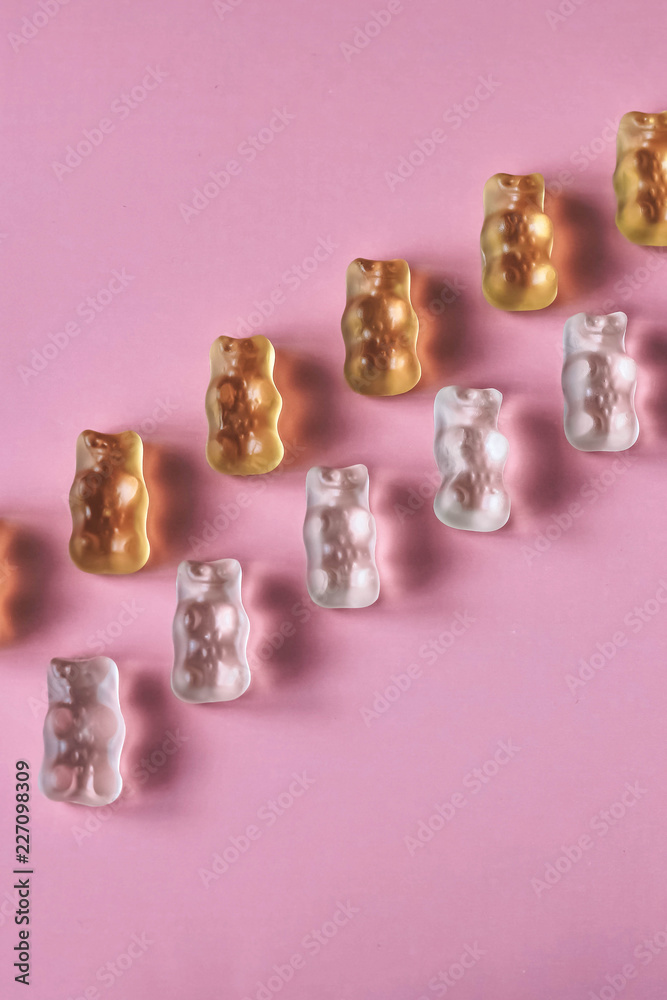 White and yellow jelly bears on pink background White and yellow jelly bears on pink background