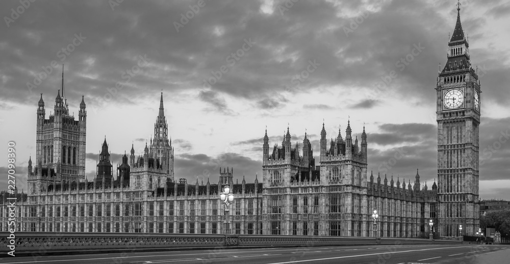Black and White panoramic view of the Houses of Parliament, Palace of Westminster and Westminster Bridge. No people, nobody. Early morning. 