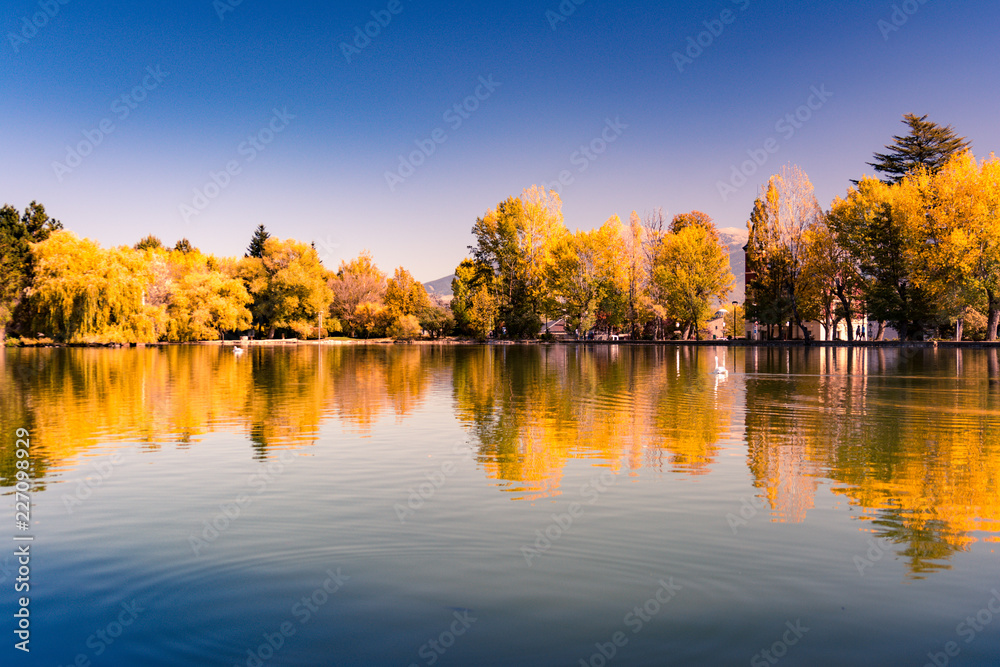 Autumn colors and reflection on Puigcerda's pond in Pyrenees. Located in north Catalonia, Spain.