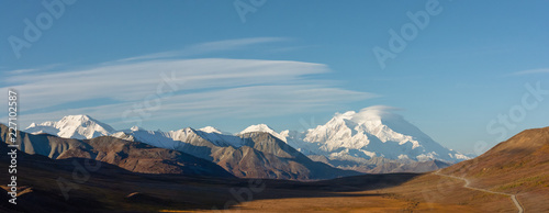 Long golden valley in front of snowy Denali in Autumn