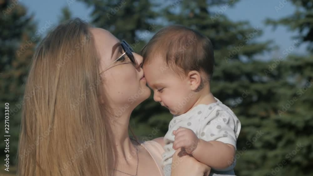 Happy mother and baby outdoors walking in summer day Happy mother and baby outdoors walking in summer day