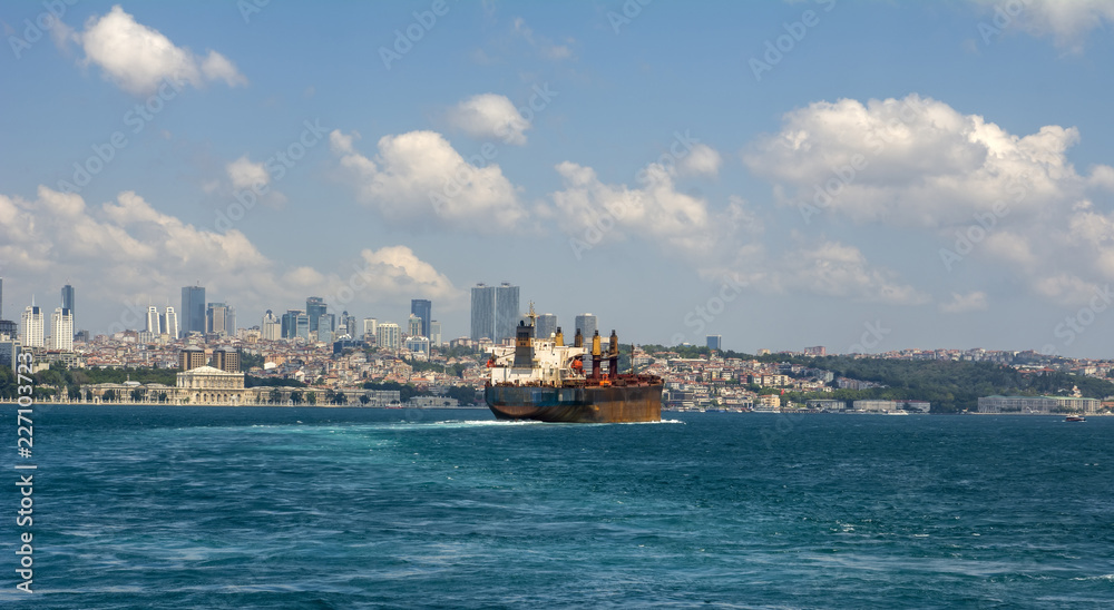 Muslim architecture and water transport in Turkey - touristic landmarks from sea voyage on Bosphorus. Cityscape of Istanbul at sunset - old mosque and turkish steamboats, view on Golden Horn.