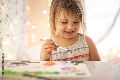 Toddler draw with brush and paint on paper in real