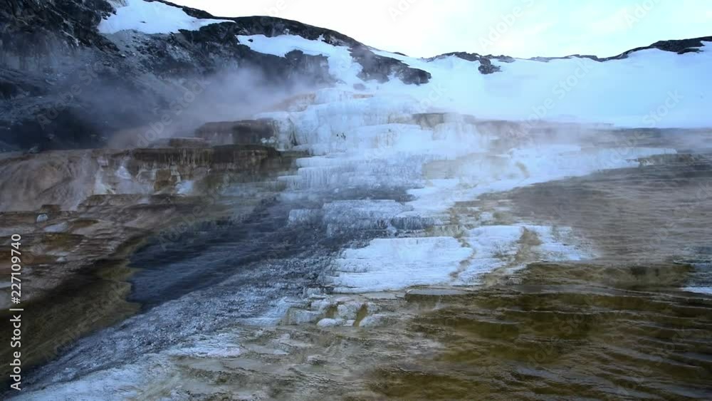 The mammoth hot spring in north Yellowstone national park in the evening in the winter with snow The mammoth hot spring in north Yellowstone national park in the evening in the winter with snow