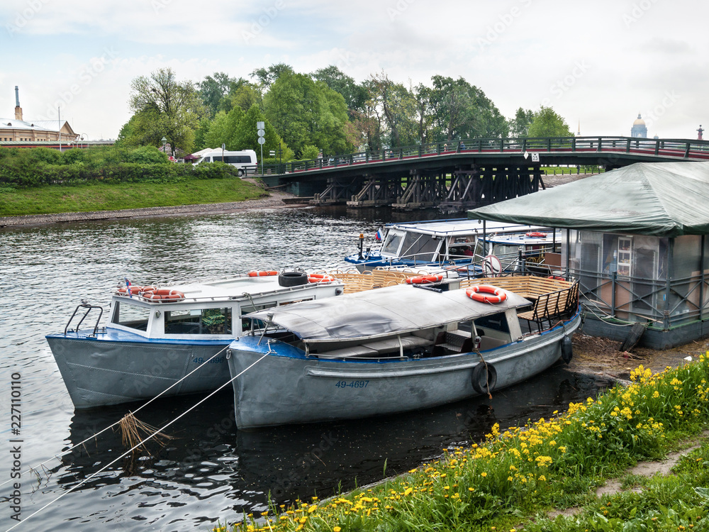 Pleasure boats at the pier near the bridge in St. Petersburg