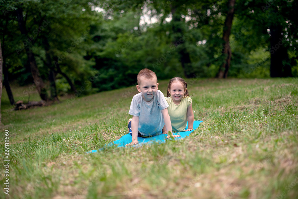 Boy and girl practicing yoga Boy and girl practicing yoga