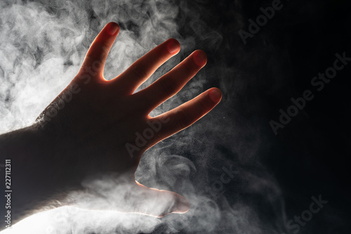 Hand on the background of steam.