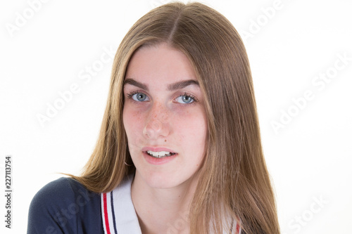 Smiling young woman posing and looking at camera over white background