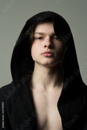 Vászonkép Portrait of young man wearing black hood, athlete or fighter before training, sports and health concept
