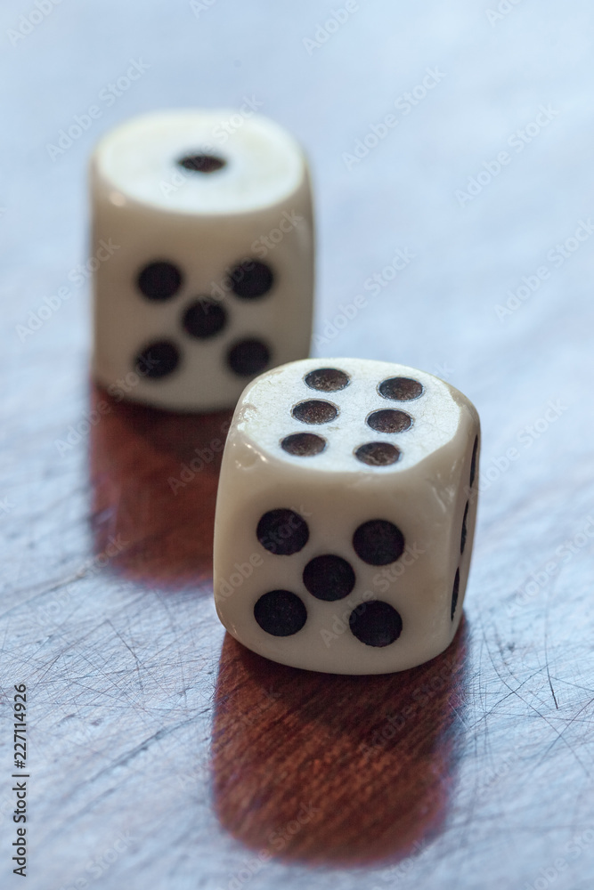 White dice on wooden background. Concept of luck, chance and leisure fun, numbers 1 and 6 White dice on wooden background. Concept of luck, chance and leisure fun, numbers 1 and 6