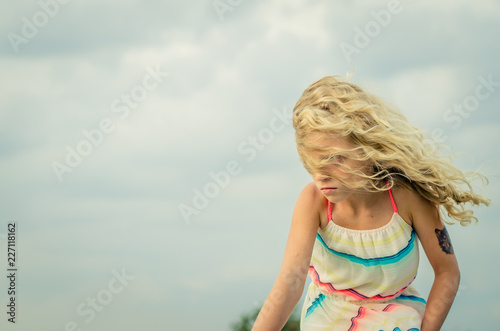 child and hair in wind