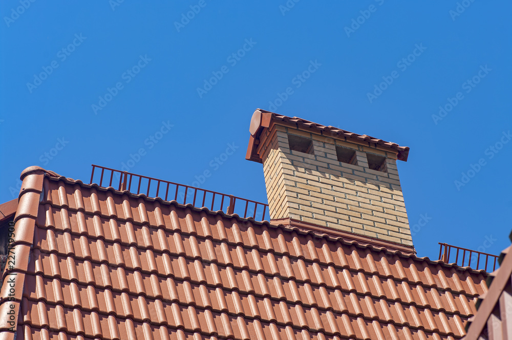 Details of the red tile roof on sky background.