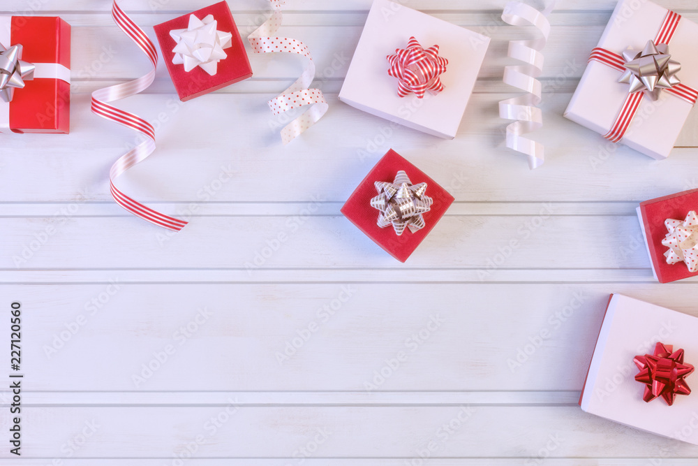 Red and white gift boxes with beautiful bows, decorative ribbons. Christmas composition with place for text, copy space. Red and white gift boxes with beautiful bows, decorative ribbons. Christmas composition with place for text, copy space.