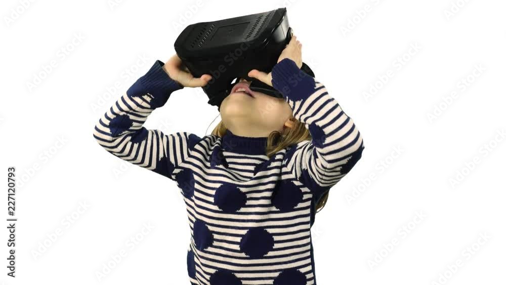 Pretty little child, caucasian 4-5 years baby girl with VR headset on white backdrop.