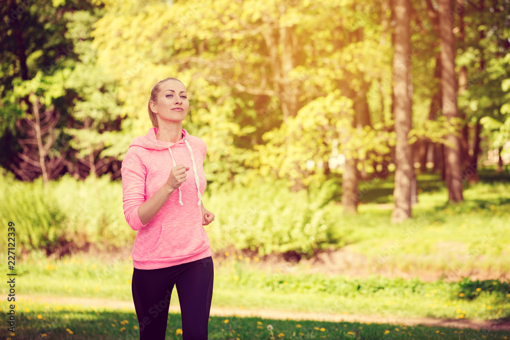 Fitness woman training and jogging in summer park Fitness woman training and jogging in summer park