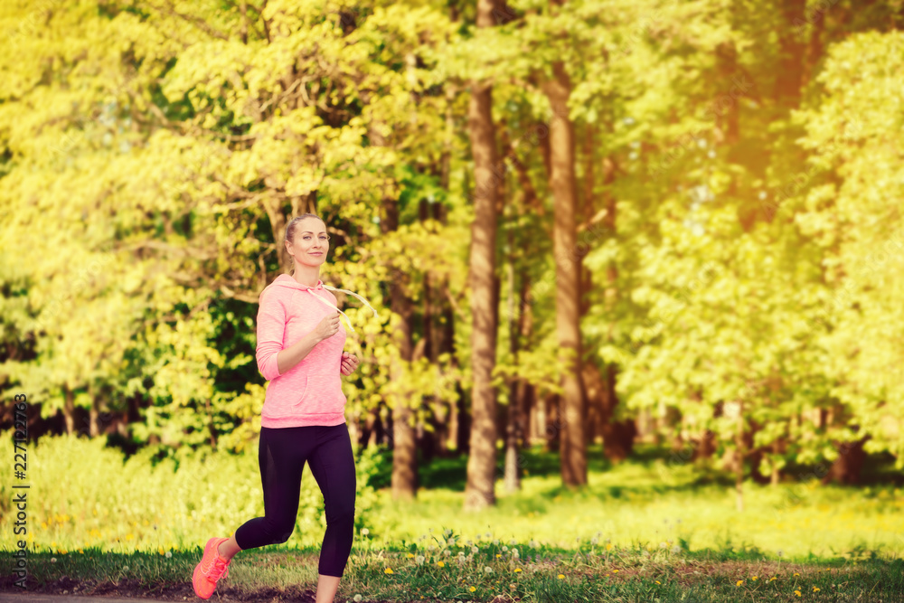Fitness woman training and jogging in summer park Fitness woman training and jogging in summer park