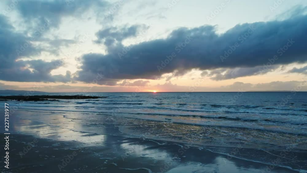 4k Drone shot over glassy ocean at sunset with clouds 4k Drone shot over glassy ocean at sunset with clouds