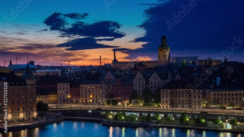 Sunset Night time lapse in Stockholm showing water and traffic passing on a bridge, Sweden