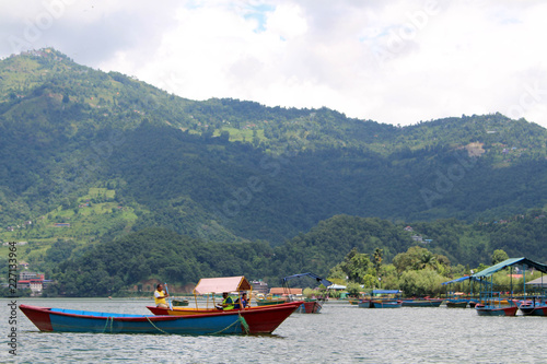 Boats around Phewa Lake and hills in Pokhara, a popular tourist destination photo