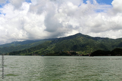 Boats around Phewa Lake and hills in Pokhara, a popular tourist destination