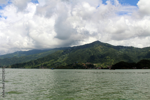 Boats around Phewa Lake and hills in Pokhara, a popular tourist destination photo