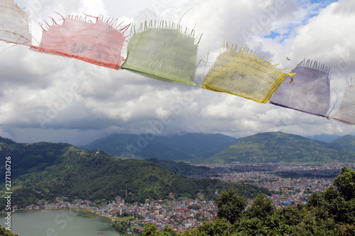 The prayer flags and Pokhara town at the World Peace Pagoda photo