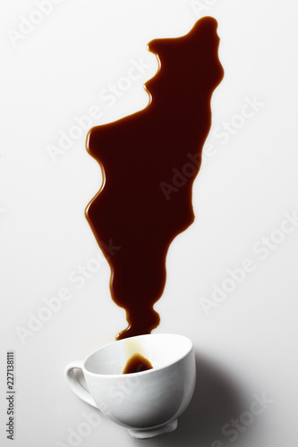 Obraz na plátne cup of coffee spilled on white background