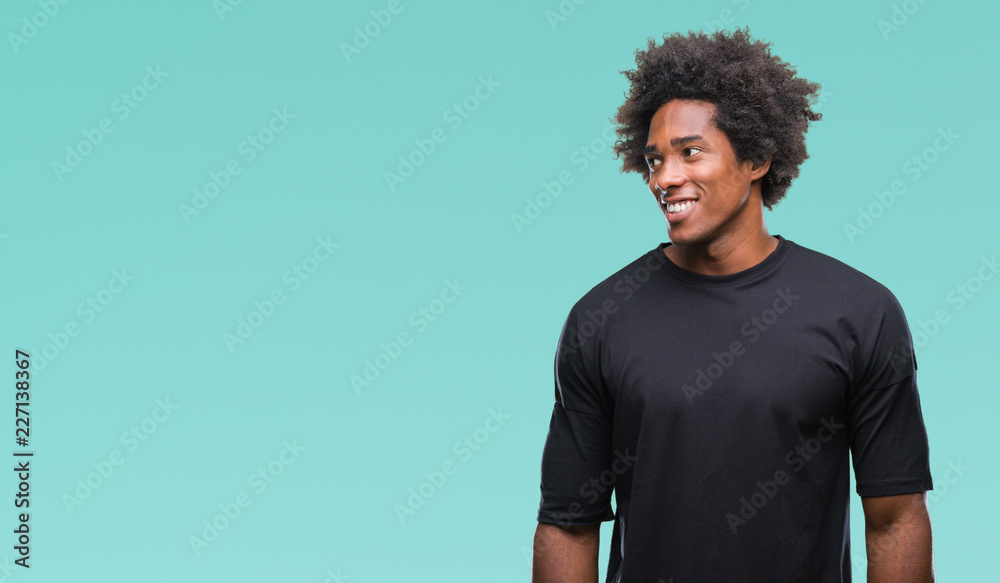 Afro american man over isolated background looking away to side with smile on face, natural expression. Laughing confident. Afro american man over isolated background looking away to side with smile on face, natural expression. Laughing confident.