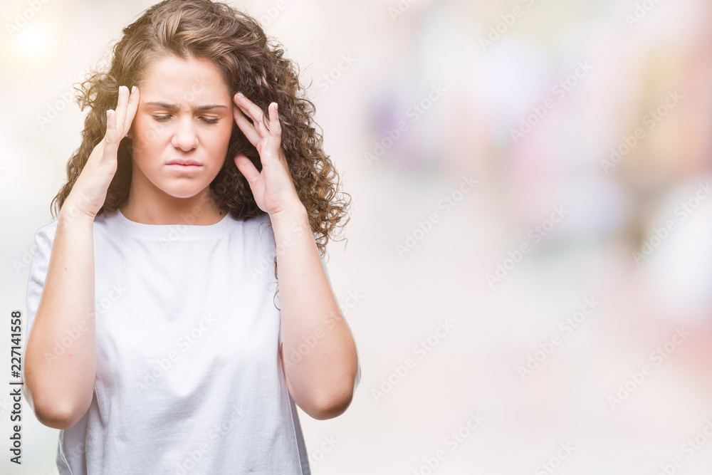 Beautiful brunette curly hair young girl wearing casual t-shirt over isolated background with hand on head for pain in head because stress. Suffering migraine. Beautiful brunette curly hair young girl wearing casual t-shirt over isolated background with hand on head for pain in head because stress. Suffering migraine.