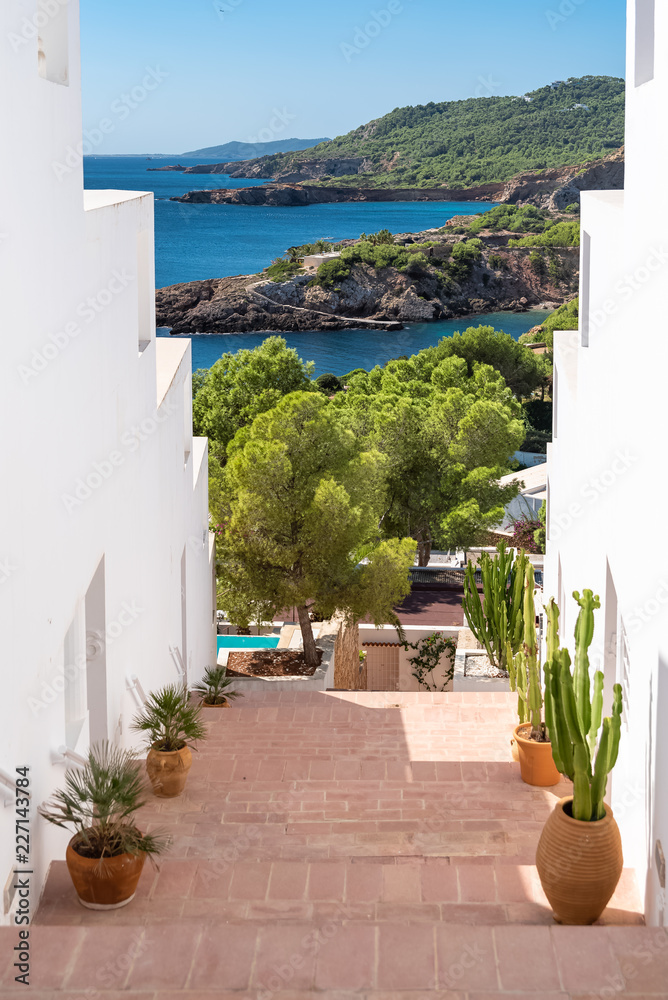 Fototapeta premium Ibiza, typical staircase with view on the sea 