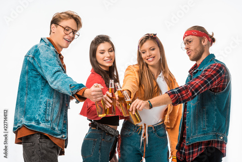 stylish young hipster friends clinking by beer bottles isolated on white