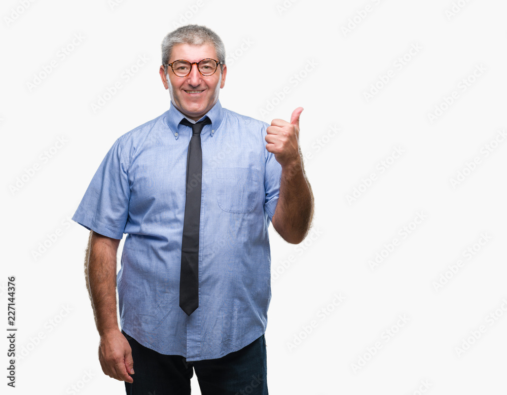 Handsome senior business man over isolated background smiling with happy face looking and pointing to the side with thumb up. Handsome senior business man over isolated background smiling with happy face looking and pointing to the side with thumb up.