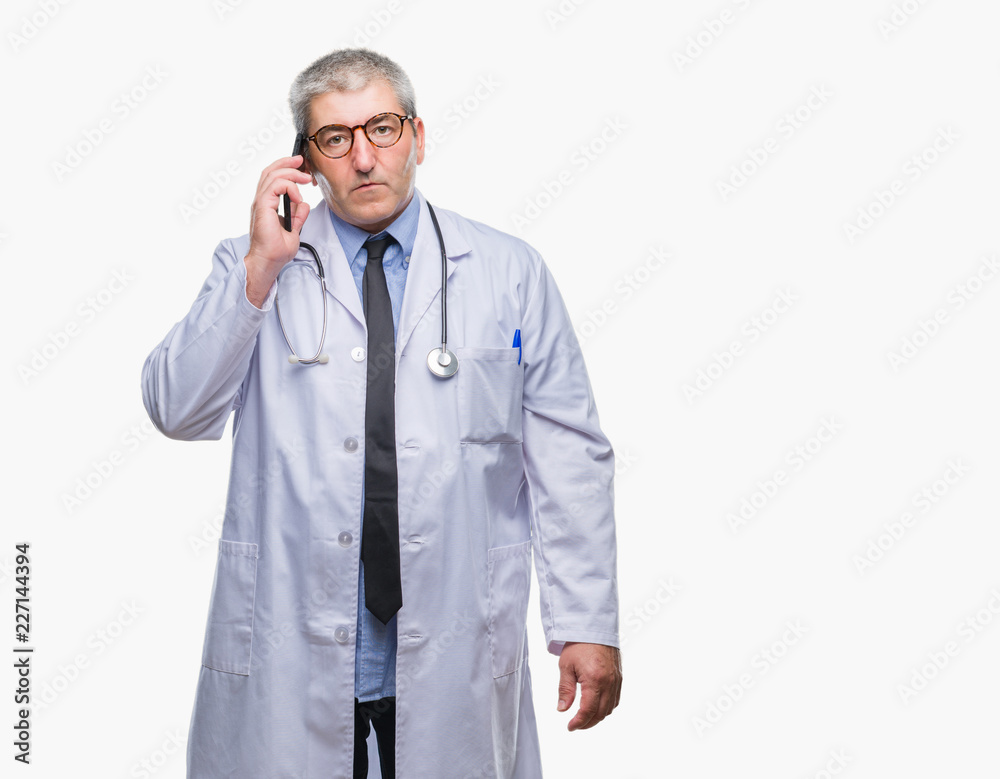 Handsome senior doctor man talking on smarpthone over isolated background with a confident expression on smart face thinking serious Handsome senior doctor man talking on smarpthone over isolated background with a confident expression on smart face thinking serious