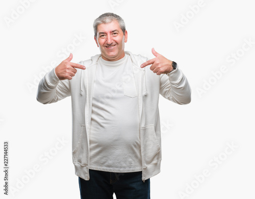Handsome senior man wearing sport clothes over isolated background looking confident with smile on face, pointing oneself with fingers proud and happy.
