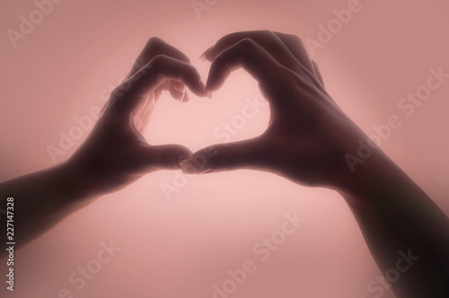 Woman hands making a heart shape