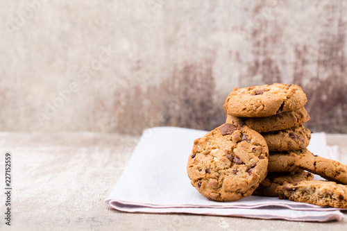 Chocolate oatmeal cookies on the wooden background.