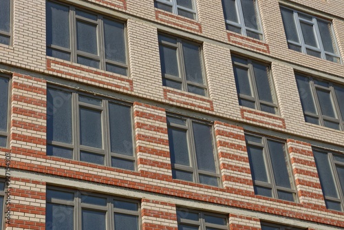 texture of gray windows on a brown brick wall