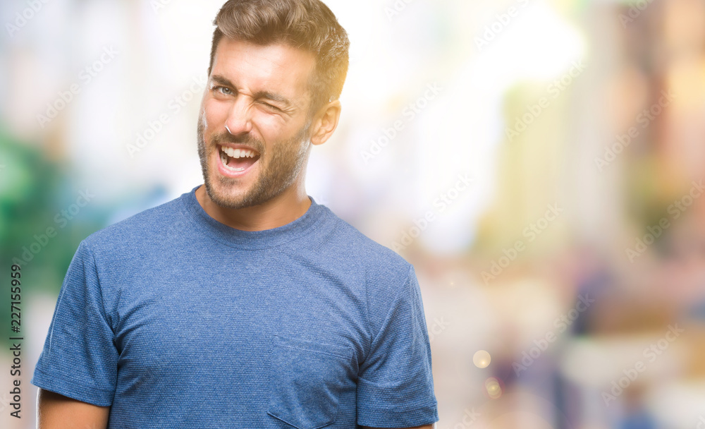 Young handsome man over isolated background winking looking at the camera with sexy expression, cheerful and happy face. Young handsome man over isolated background winking looking at the camera with sexy expression, cheerful and happy face.