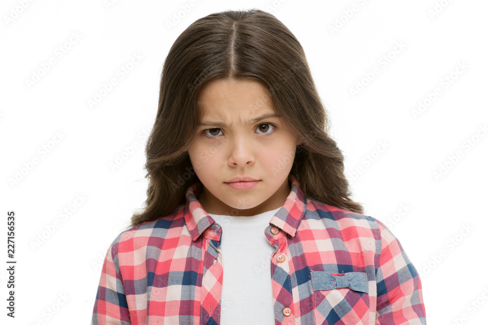 Little girl raise eyebrow isolated on white. Confident child with long brunette hair. Are you serious. Stop kidding me. Glance full of suspect. Kid looks offended and frowning. Stop bullying concept Little girl raise eyebrow isolated on white. Confident child with long brunette hair. Are you serious. Stop kidding me. Glance full of suspect. Kid looks offended and frowning. Stop bullying concept