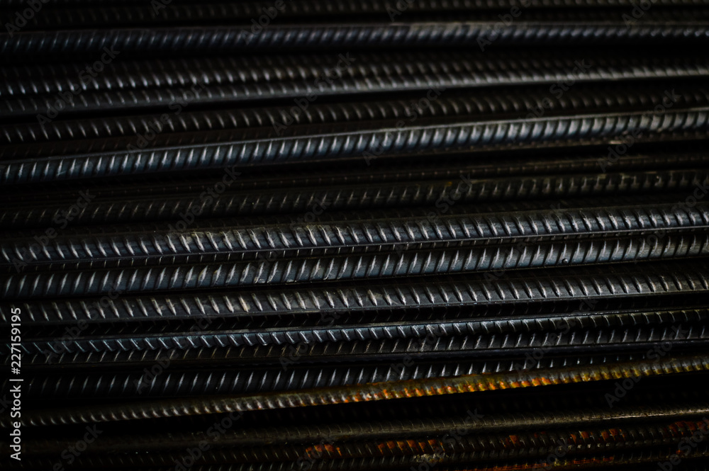 closeup of hard rods division rebars, used on stacked construction concrete background. industrial professional equipment pattern, stiff macro perspective image for reinforcement and construction. closeup of hard rods division rebars, used on stacked construction concrete background. industrial professional equipment pattern, stiff macro perspective image for reinforcement and construction.