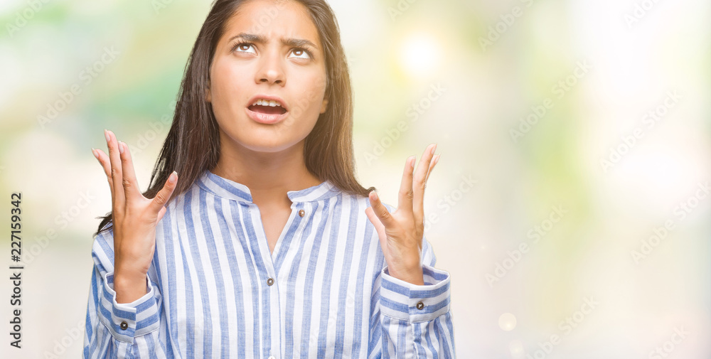 Young beautiful arab woman over isolated background crazy and mad shouting and yelling with aggressive expression and arms raised. Frustration concept. Young beautiful arab woman over isolated background crazy and mad shouting and yelling with aggressive expression and arms raised. Frustration concept.