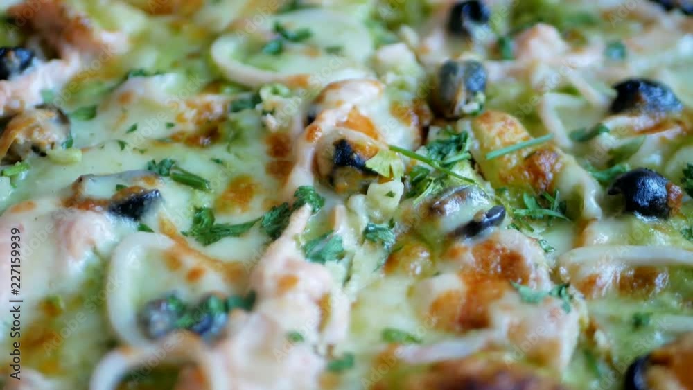 Fresh hot pizza with hot cheese, mussels, olives, parsley and dill Fresh hot pizza with hot cheese, mussels, olives, parsley and dill