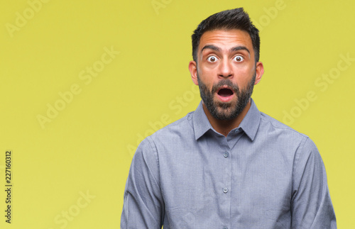 Adult hispanic man over isolated background afraid and shocked with surprise expression, fear and excited face. © Krakenimages.com