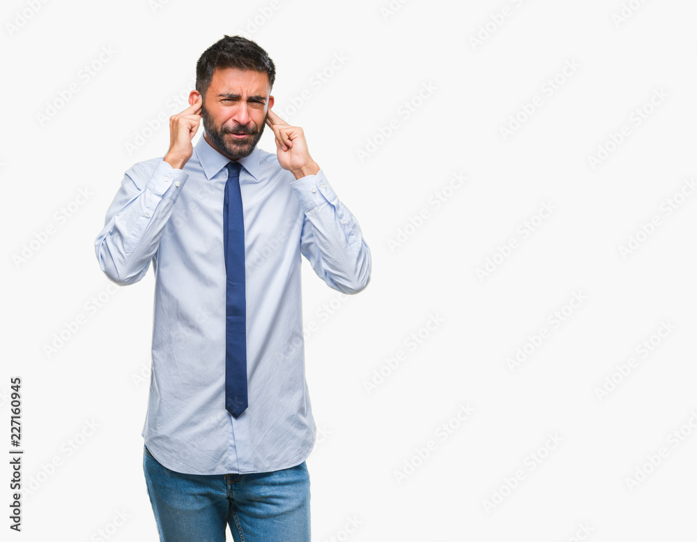 Adult hispanic business man over isolated background covering ears with fingers with annoyed expression for the noise of loud music. Deaf concept. Adult hispanic business man over isolated background covering ears with fingers with annoyed expression for the noise of loud music. Deaf concept.