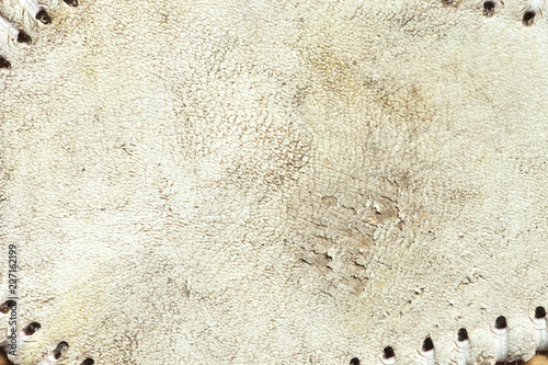 Grungy leather texture of a used baseball