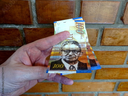 Money of Israel - 100 (one hundred) new shekels bills in the hand