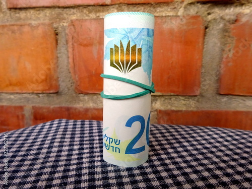 Israel money - 200 shekels rolled up in a roll